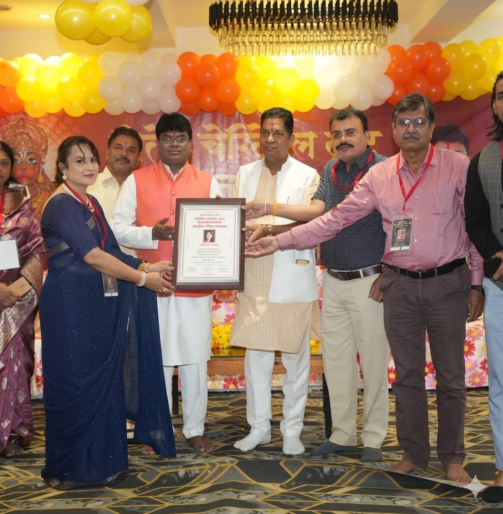 Astro Vandana receiving recognition at a spiritual event